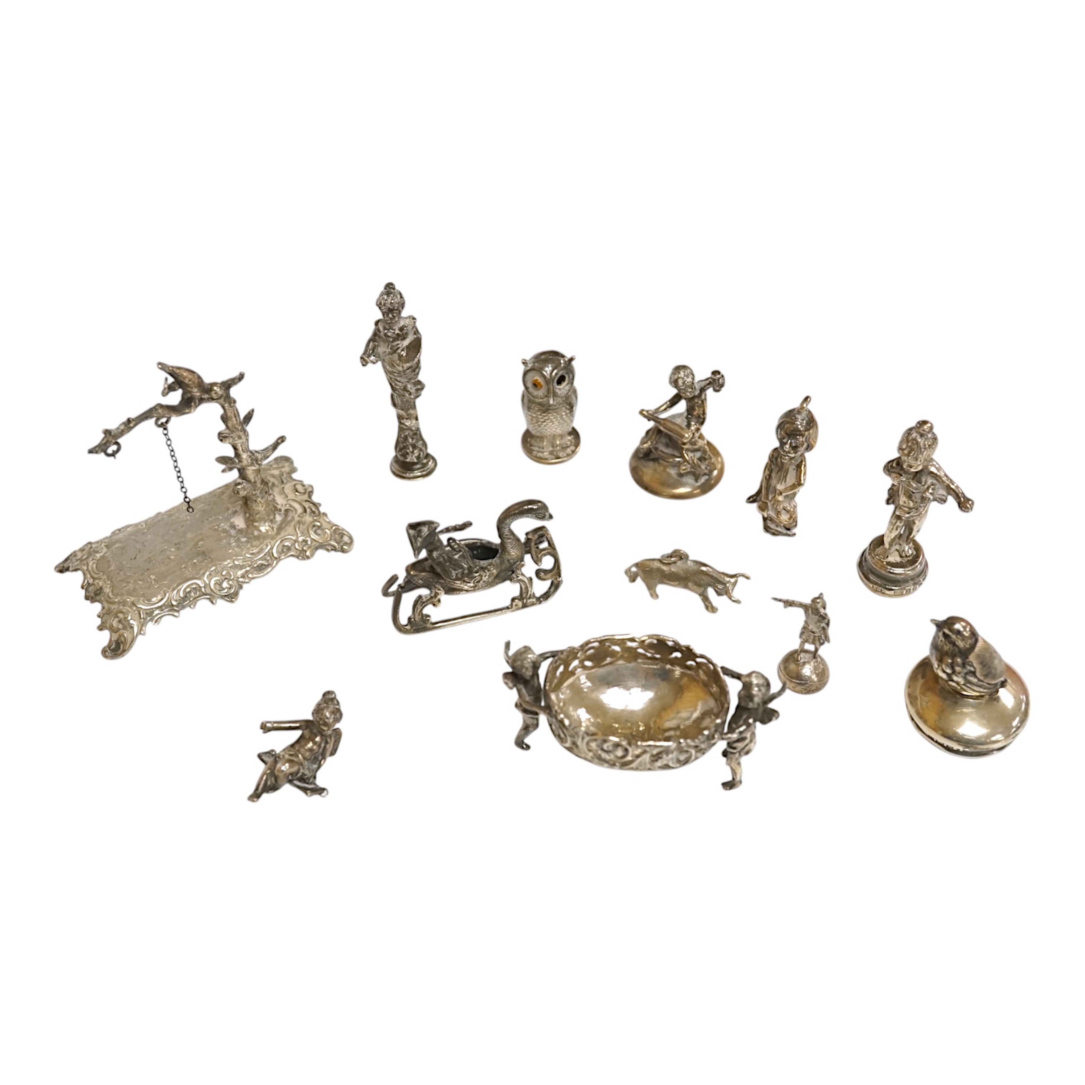 A collection of miniature silver and white metal figures and groups etc. including a swan sleigh, import marks for Chester, 1900, 41mm. Condition - poor to fair